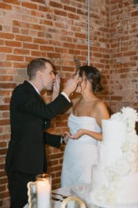 A man and woman cutting their wedding cake.